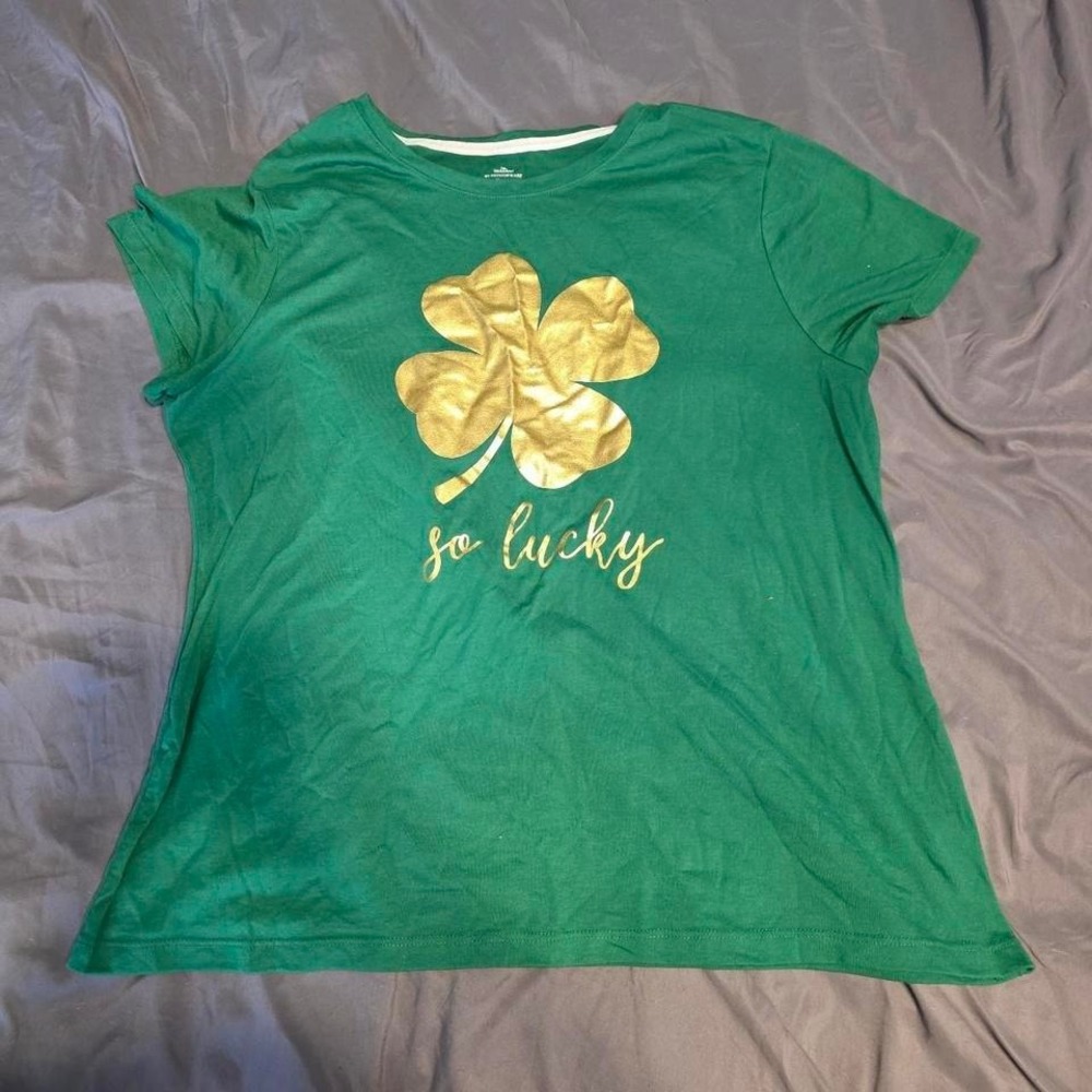 green St. Patrick's Day shirt with gold shamrock and‎ "so lucky" text,